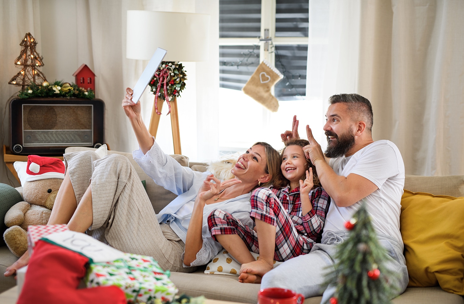 Family,With,Small,Daughter,Indoors,At,Home,At,Christmas,,Having